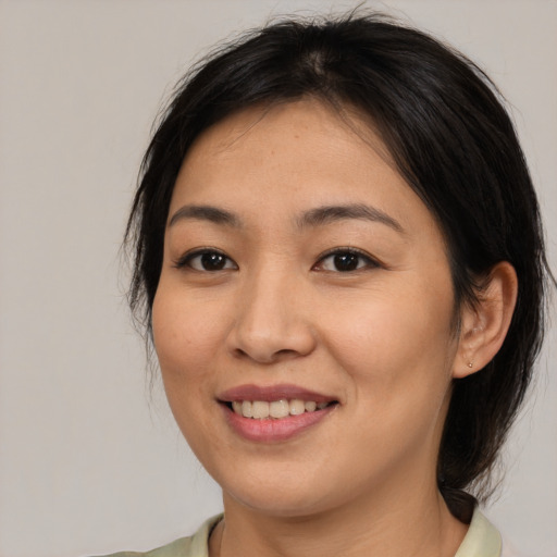 Joyful asian young-adult female with medium  brown hair and brown eyes