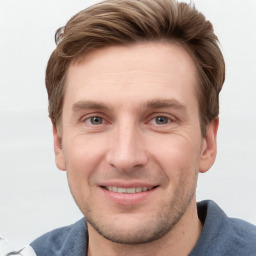 Joyful white young-adult male with short  brown hair and grey eyes