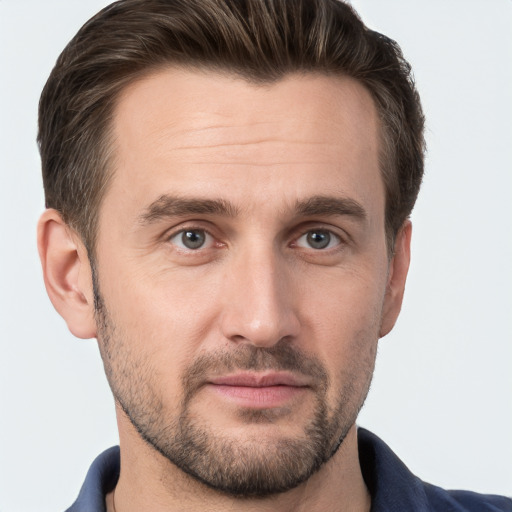 Joyful white young-adult male with short  brown hair and grey eyes