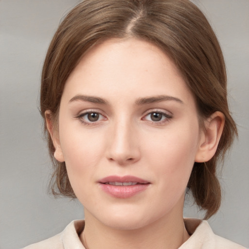 Joyful white young-adult female with medium  brown hair and grey eyes