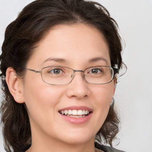 Joyful white young-adult female with medium  brown hair and grey eyes