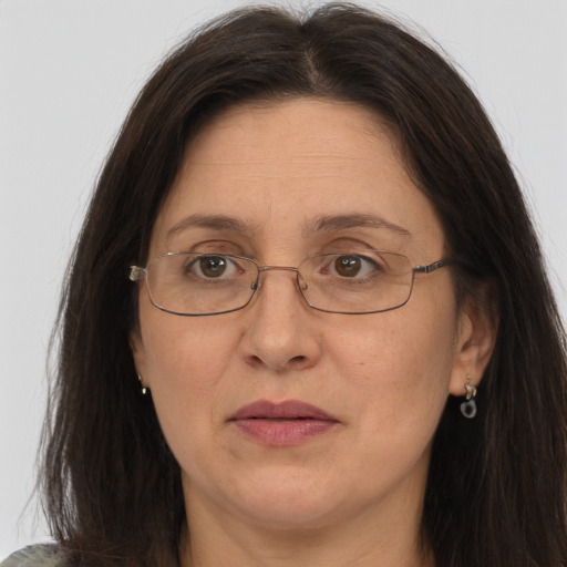 Joyful white adult female with long  brown hair and brown eyes