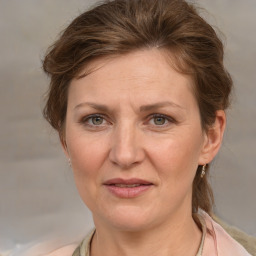 Joyful white adult female with medium  brown hair and blue eyes