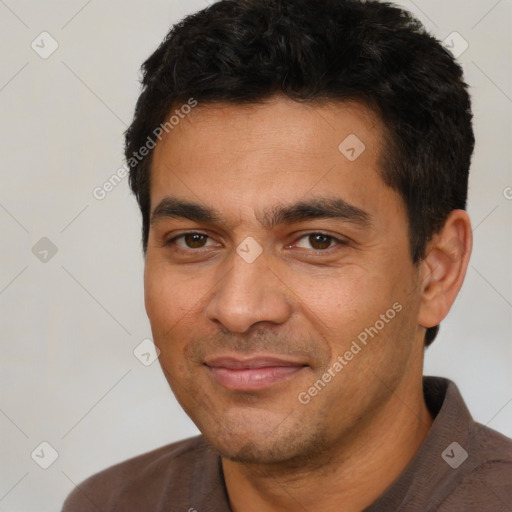 Joyful white young-adult male with short  black hair and brown eyes