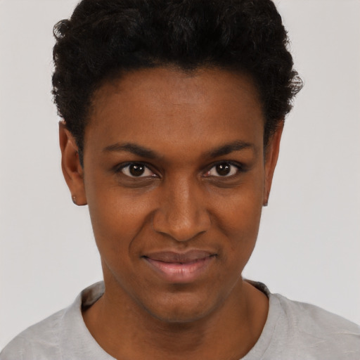 Joyful black young-adult female with short  black hair and brown eyes