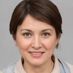 Joyful white young-adult female with medium  brown hair and brown eyes