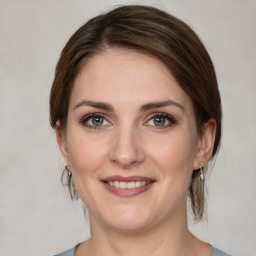 Joyful white young-adult female with medium  brown hair and green eyes