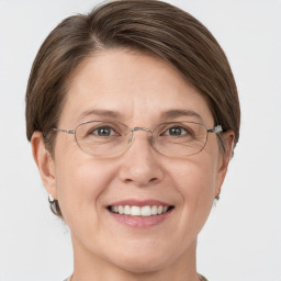 Joyful white adult female with short  brown hair and grey eyes