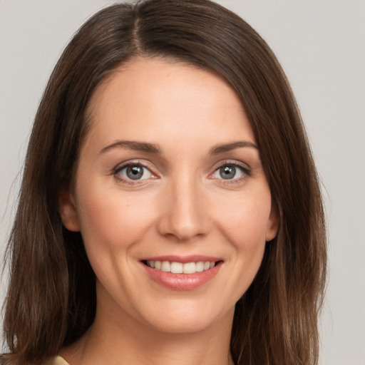 Joyful white young-adult female with long  brown hair and brown eyes