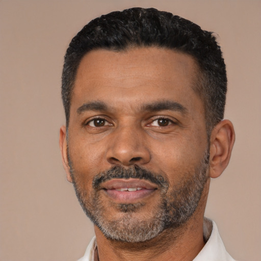 Neutral latino adult male with short  black hair and brown eyes