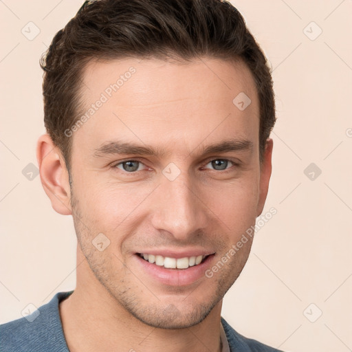 Joyful white young-adult male with short  brown hair and grey eyes