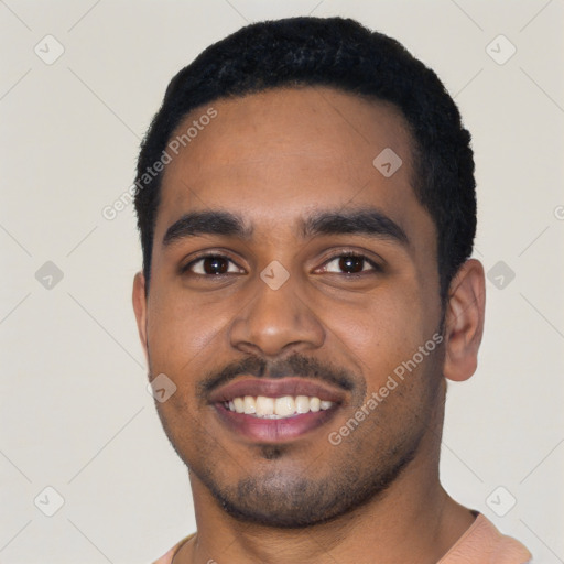 Joyful black young-adult male with short  black hair and brown eyes