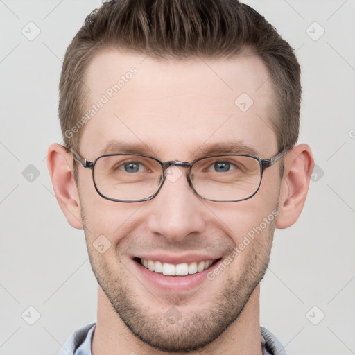 Joyful white young-adult male with short  brown hair and grey eyes