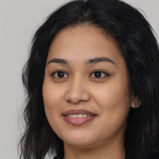 Joyful asian young-adult female with long  brown hair and brown eyes