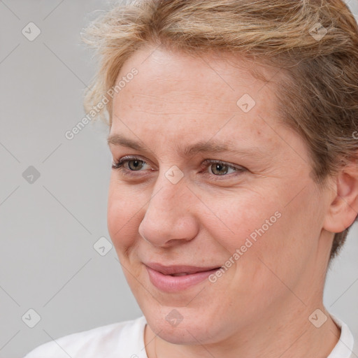 Joyful white adult female with short  brown hair and brown eyes