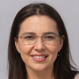 Joyful white adult female with long  brown hair and brown eyes