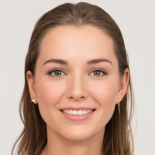 Joyful white young-adult female with long  brown hair and grey eyes