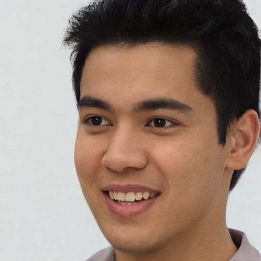 Joyful latino young-adult male with short  brown hair and brown eyes