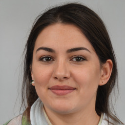 Joyful white young-adult female with medium  brown hair and brown eyes