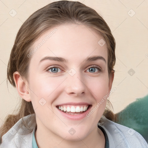 Joyful white young-adult female with medium  brown hair and grey eyes