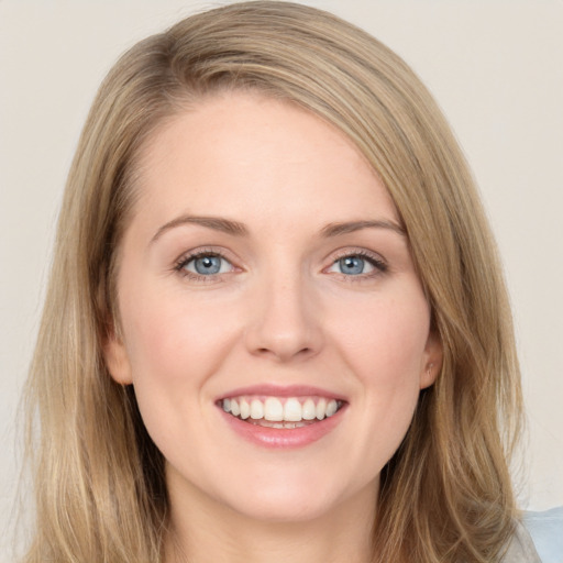 Joyful white young-adult female with long  brown hair and blue eyes