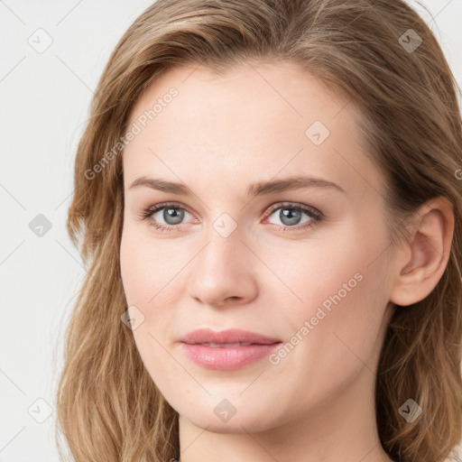 Joyful white young-adult female with long  brown hair and blue eyes