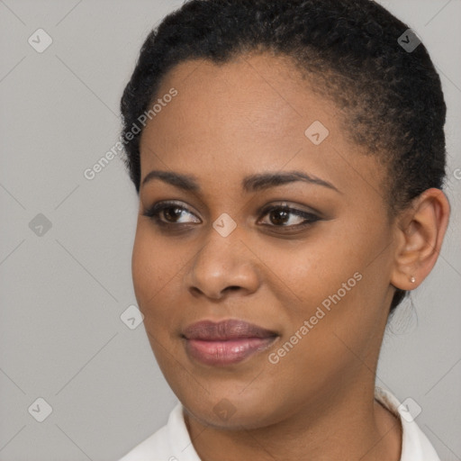 Joyful black young-adult female with short  brown hair and brown eyes