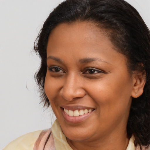 Joyful black young-adult female with medium  brown hair and brown eyes