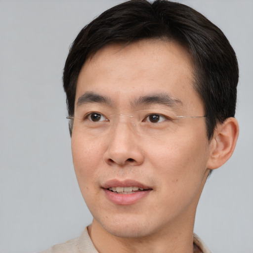 Joyful asian young-adult male with short  brown hair and brown eyes