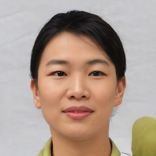 Joyful asian young-adult female with short  brown hair and brown eyes