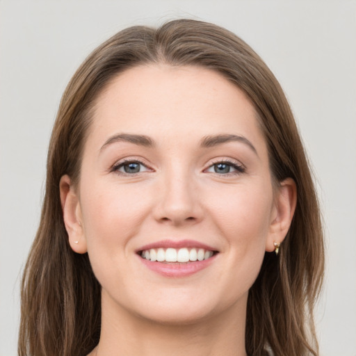 Joyful white young-adult female with long  brown hair and grey eyes