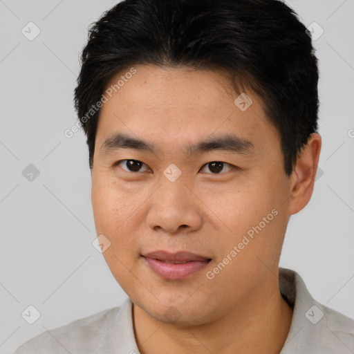 Joyful asian young-adult male with short  brown hair and brown eyes