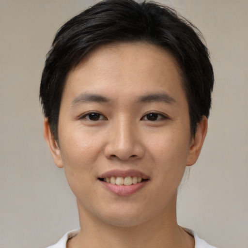 Joyful asian young-adult female with short  brown hair and brown eyes