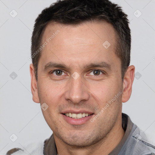 Joyful white adult male with short  brown hair and brown eyes