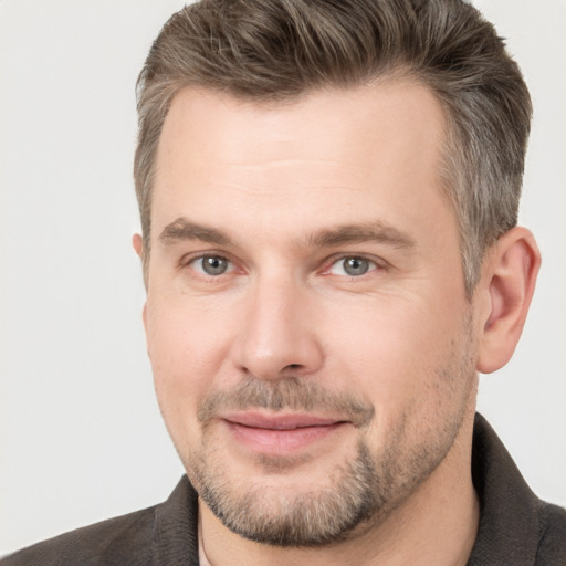 Joyful white adult male with short  brown hair and brown eyes