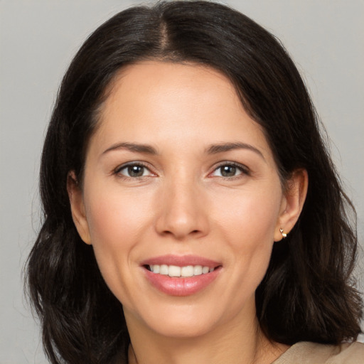 Joyful white young-adult female with medium  brown hair and brown eyes