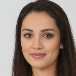 Joyful latino young-adult female with long  brown hair and brown eyes