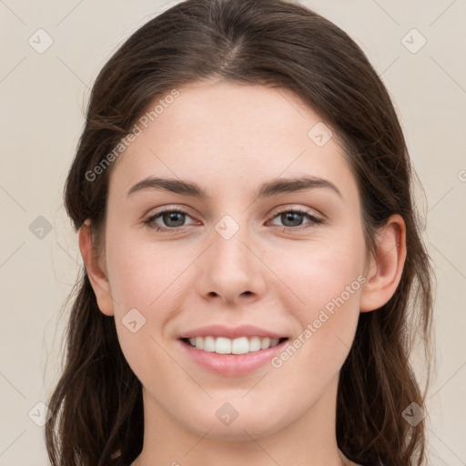 Joyful white young-adult female with long  brown hair and grey eyes