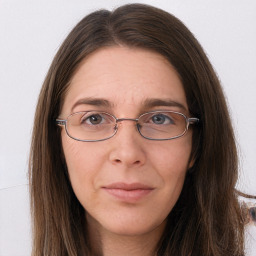 Joyful white adult female with long  brown hair and grey eyes