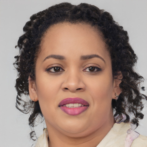 Joyful black young-adult female with medium  brown hair and brown eyes