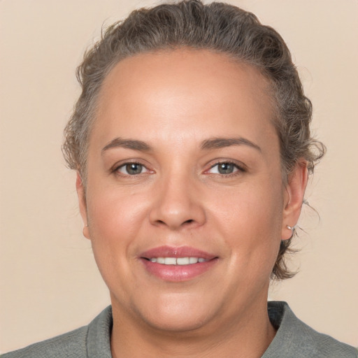 Joyful white adult female with short  brown hair and brown eyes