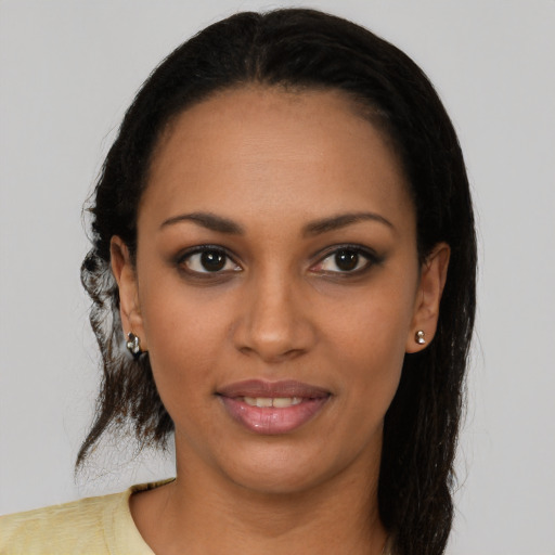 Joyful black young-adult female with medium  brown hair and brown eyes