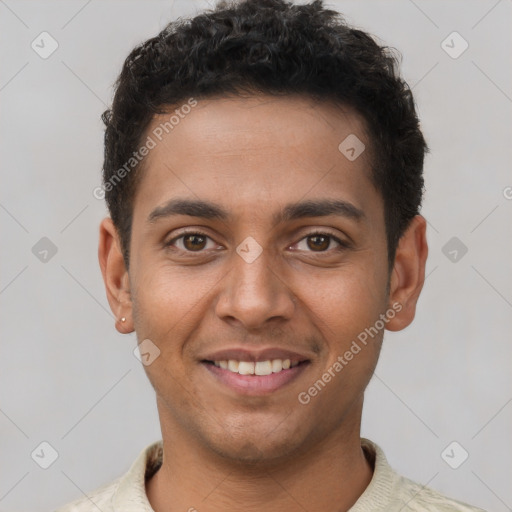 Joyful latino young-adult male with short  brown hair and brown eyes