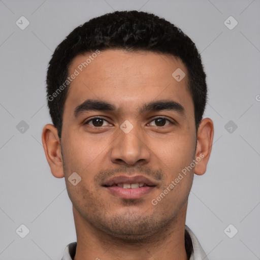 Joyful latino young-adult male with short  black hair and brown eyes