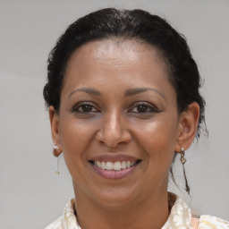 Joyful black adult female with short  brown hair and brown eyes