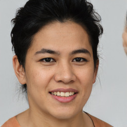 Joyful asian young-adult female with short  brown hair and brown eyes