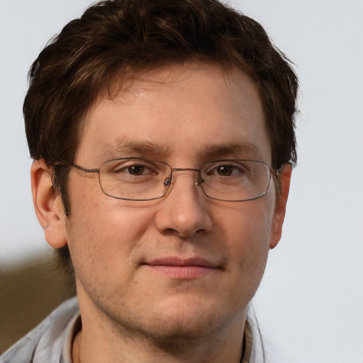 Joyful white adult male with short  brown hair and brown eyes