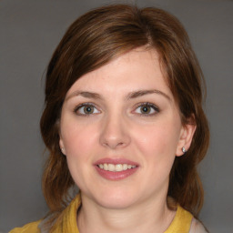 Joyful white young-adult female with medium  brown hair and blue eyes