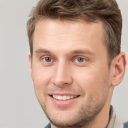 Joyful white young-adult male with short  brown hair and brown eyes