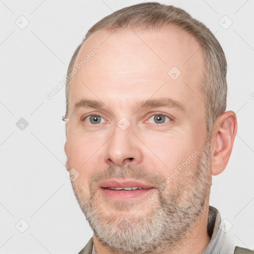 Joyful white adult male with short  brown hair and grey eyes